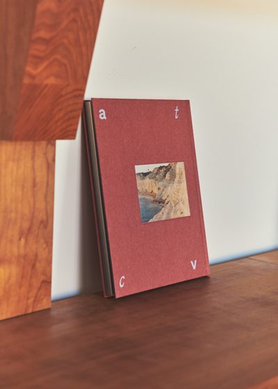 A book on the cherry wood shelving. Photo Armin Tehrani